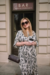 a lady in a floral print lantern sleeve dress